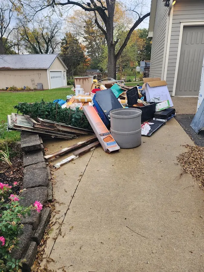 Dumpster being loaded with debris for Estate Cleanout Dumpster Rental in Watertown